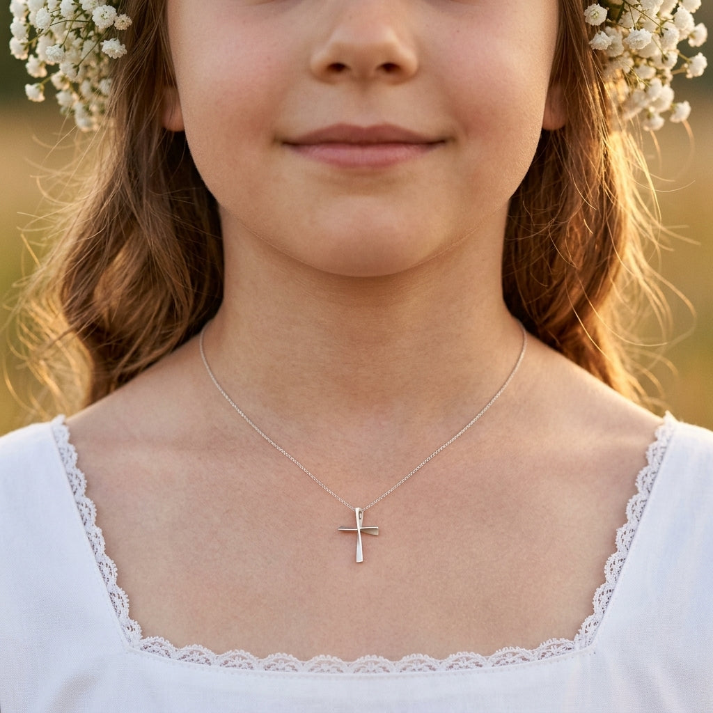 Mädchen trägt silbernen Kreuz-Anhänger Twist an feiner Kette, weißes Kleid mit Spitze, Baby's Breath Blumenkranz